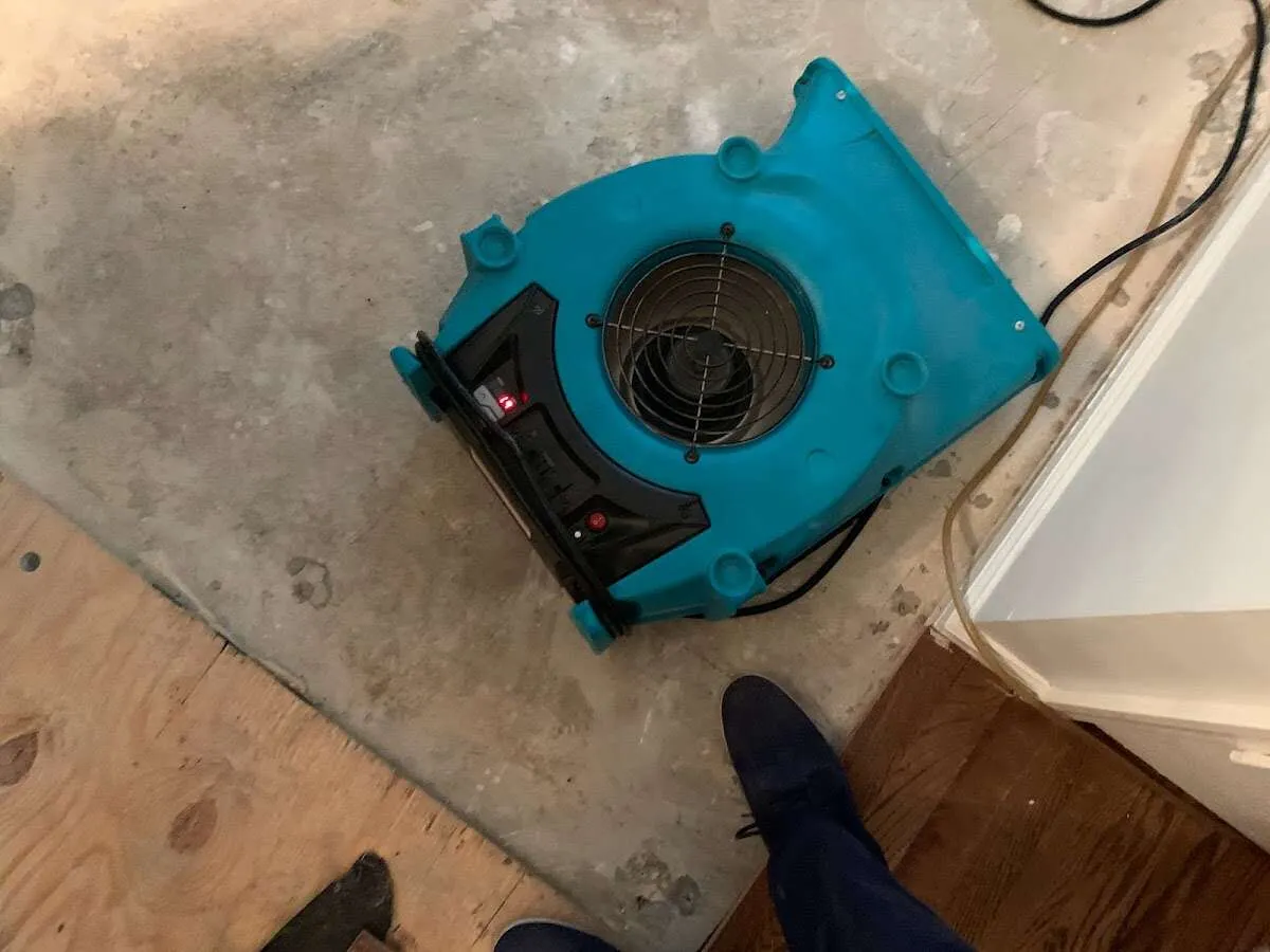 Air mover drying subfloor during Commercial Water Damage Restoration in West Palm Beach